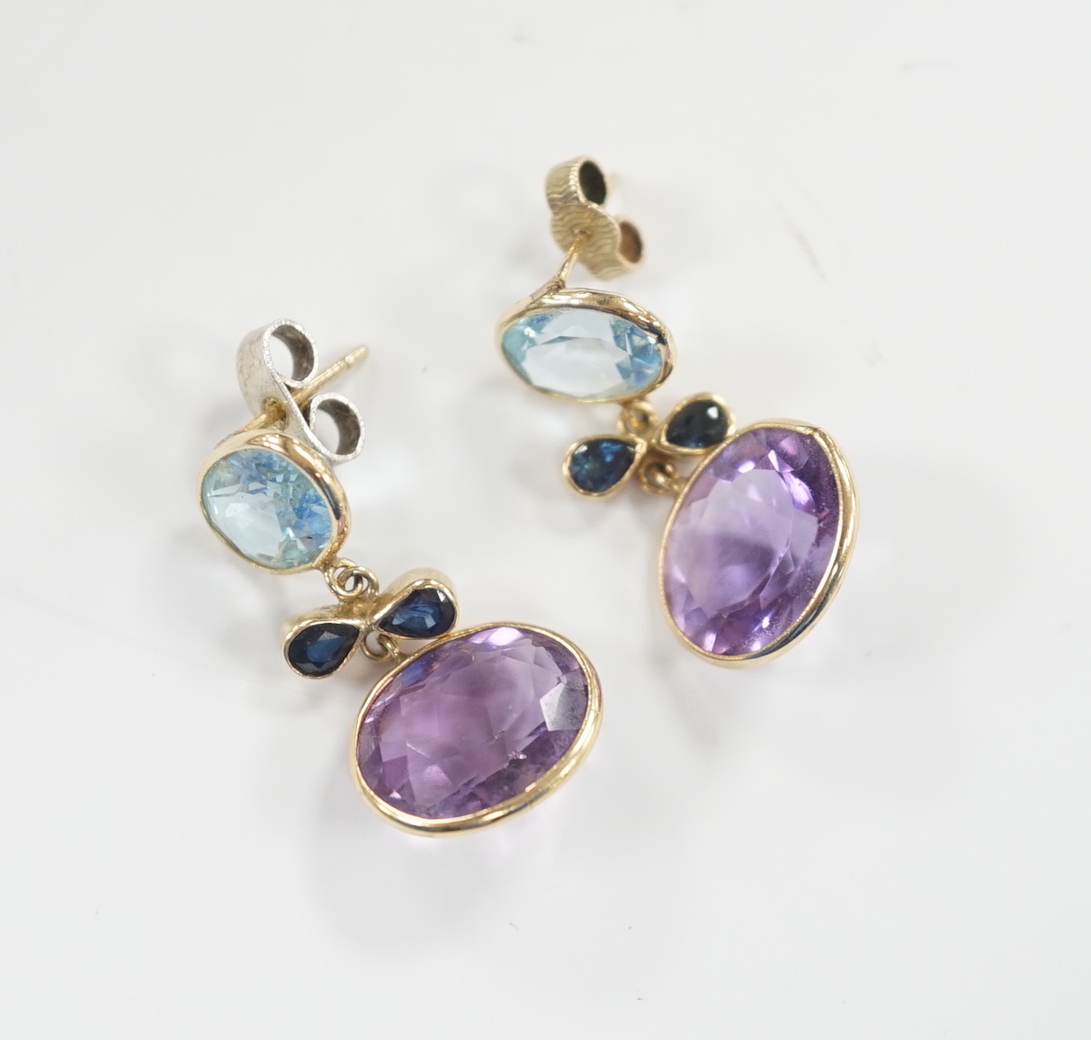 A pair of yellow metal and four stone, blue topaz, amethyst and sapphire? set drop earrings, 25mm, gross weight 4.7 grams.